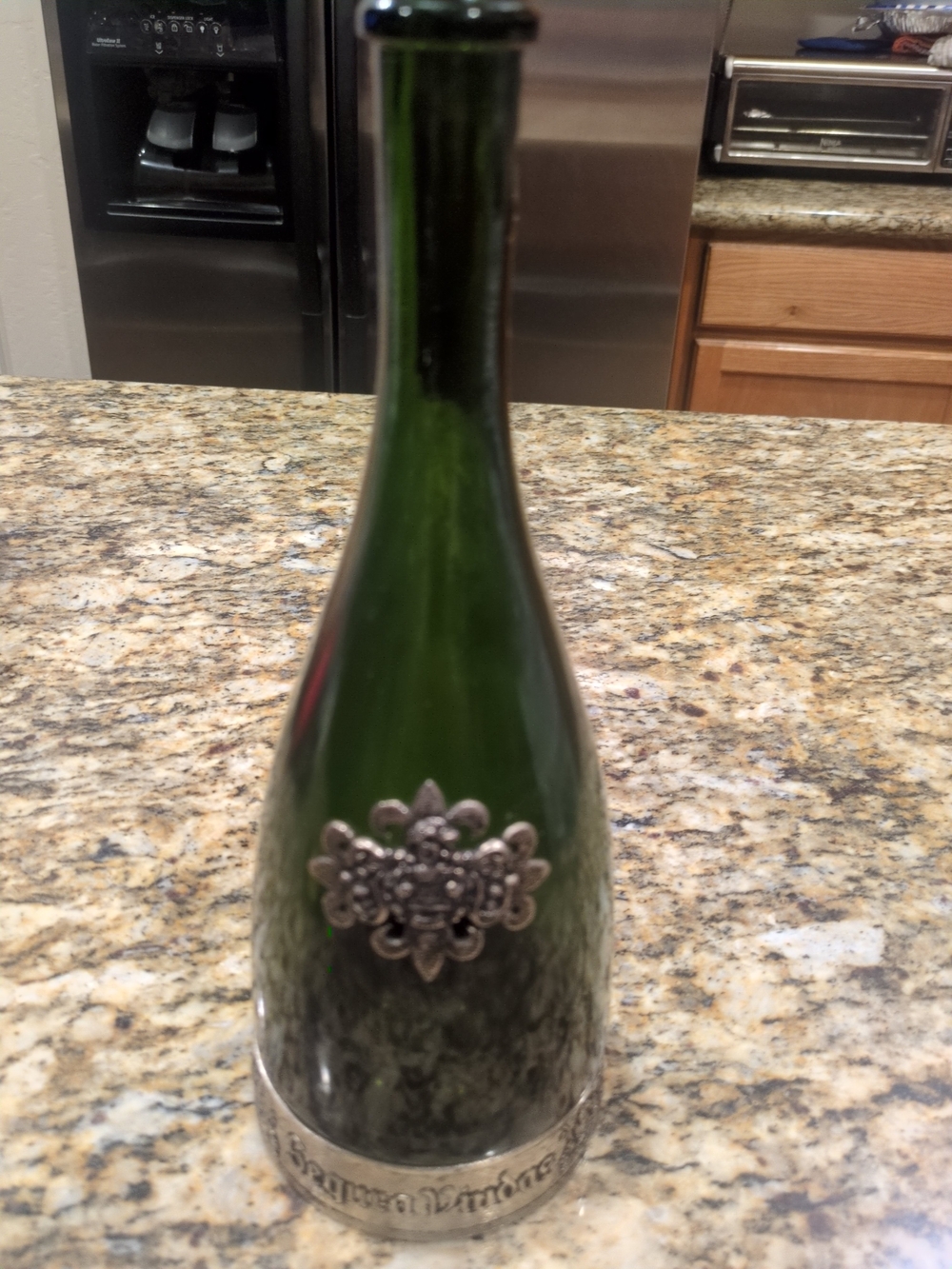 Vintage Segura Viudas Brut Cava bottle with decorative metal embellishments.